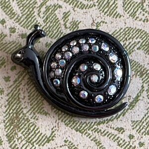 Tiny gunmetal snail brooch with AB rhinestones that swirl around his shell